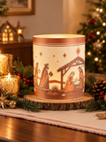Nativity cylinder showing the stable, the three kings and stars, shown with Christmas candles and greenery